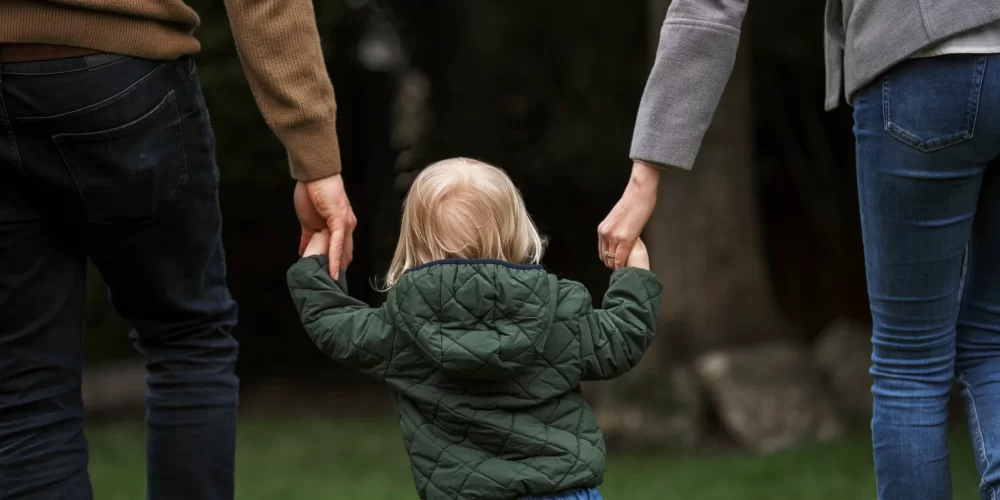 parents-walking-with-kid-park